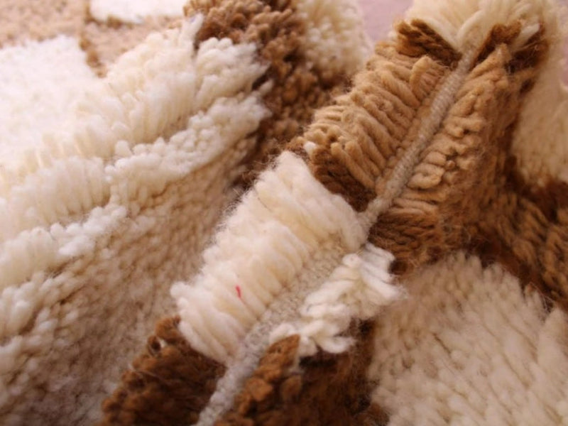 Close view of the wool pile and woven structure of a handmade Moroccan rug