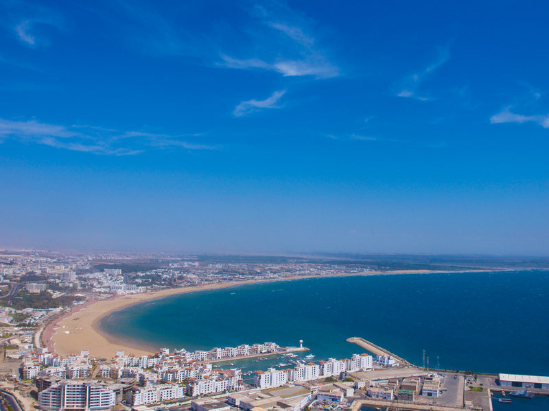 View from Agadir Oufella over the port, marina, city buildings and curving Atlantic beach, photographed in 2010.