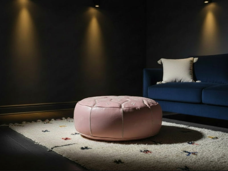 Luxury Moroccan home decor — Azilal Rug, soft pink leather Tile ottoman and white Pom Pom cushion in a dark moody living room — Moroccan Corridor®