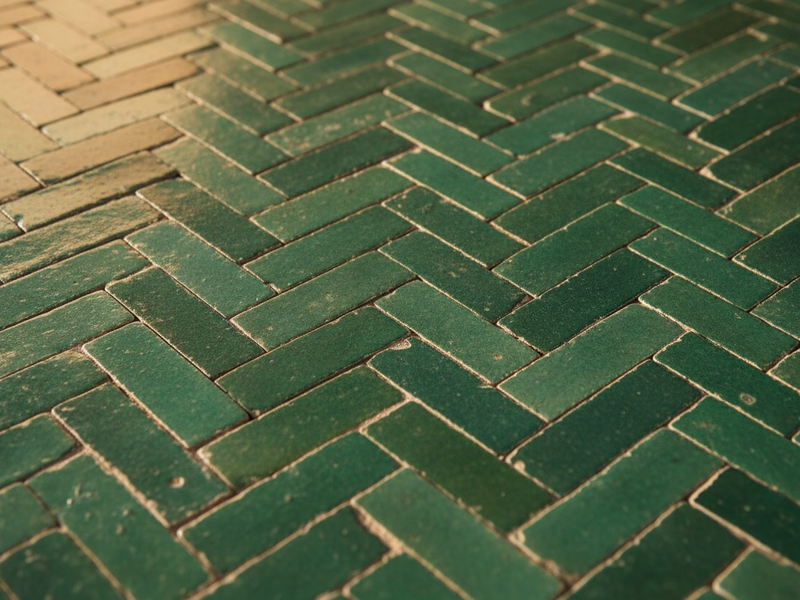 Green glazed zellige tilework in a chevron herringbone pattern — Kasbah Museum, Tangier — Moroccan Corridor