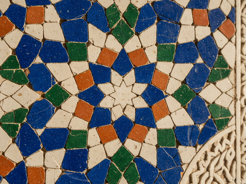 Hand-cut Moroccan zellige tilework in cobalt blue, ivory, terracotta and green — Islamic geometric art in an authentic Moroccan interior