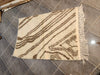 Handwoven Moroccan Azilal rug — workshop view, ivory and brown abstract
