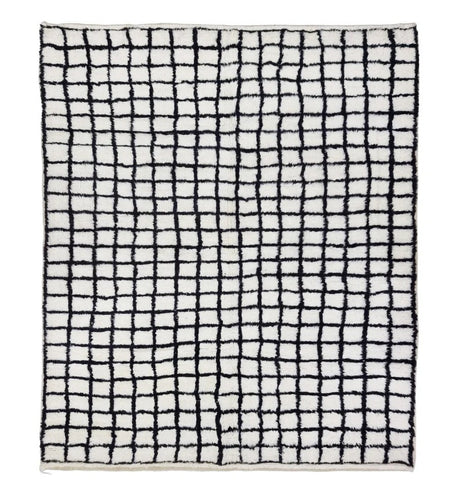 A rectangular area rug with a black hand-drawn grid pattern on an off-white background, shown flat against a solid white backdrop.