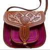 Brown leather handbag with intricate designs on a white background