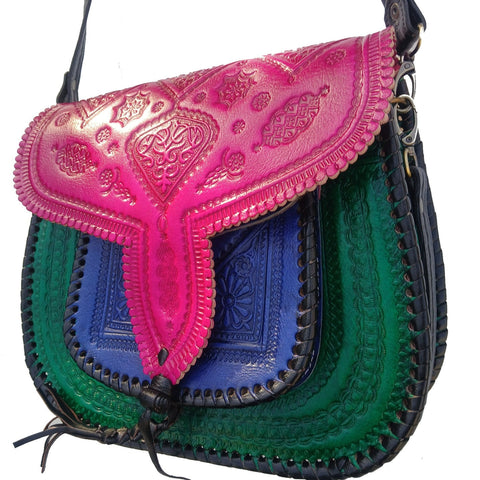 Multicolored handbag with pink, blue, and green sections on a white background