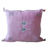 Pink pillow with decorative stitching on a white background