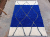 Izri — The Unbroken Line, detail view of continuous Amazigh lozenge grid across ivory and cobalt fields
