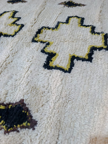 Full view of Azel Azilal rug — ivory field with black and yellow cross medallions, Azilal Morocco