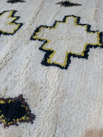Full view of Azel Azilal rug — ivory field with black and yellow cross medallions, Azilal Morocco