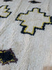 Full view of Azel Azilal rug — ivory field with black and yellow cross medallions, Azilal Morocco