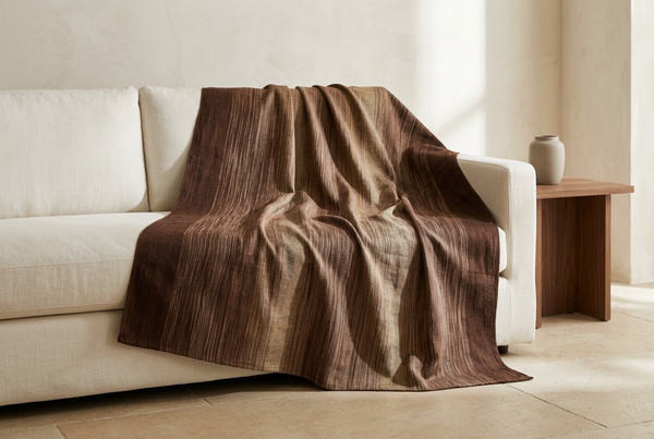 Brown Moroccan blanket draped over an ivory linen sofa