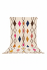 Moroccan Azilal rug, ivory ground with multicolor diamond pattern, studio white background