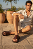 Male model wearing brown caramel leather sandals