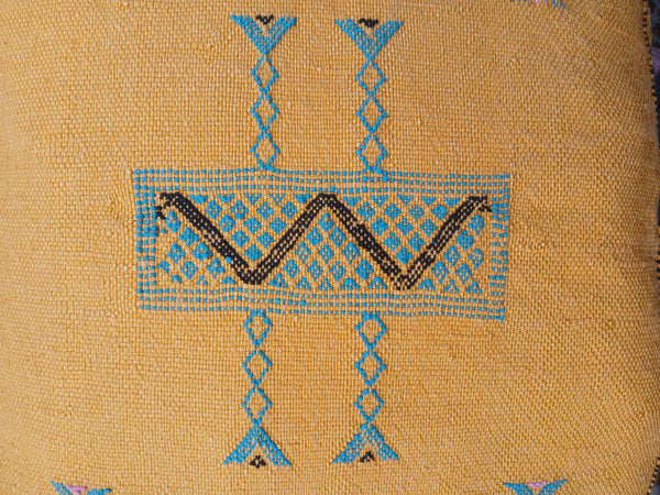 Textile with blue and black geometric patterns on a beige background