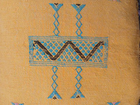 Textile with blue and black geometric patterns on a beige background