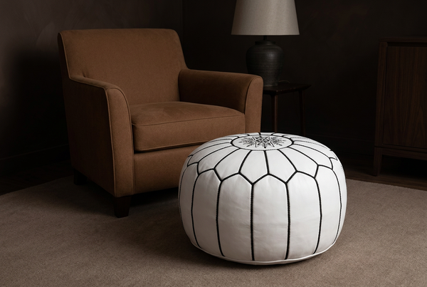 White and Black pouf hero in a dark, warm interior